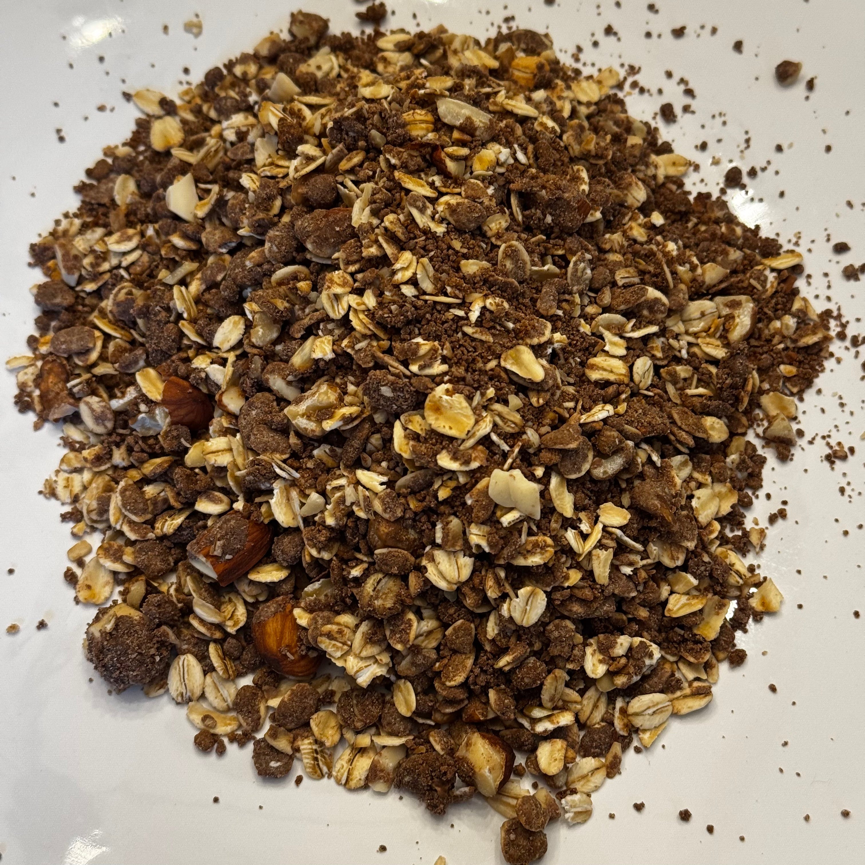 Burlyman Chocolate Protein Granola close-up showing chocolate oat clusters